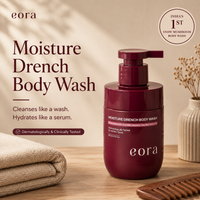 Eora Moisture Drench Body Wash bottle with a folded towel and wooden comb